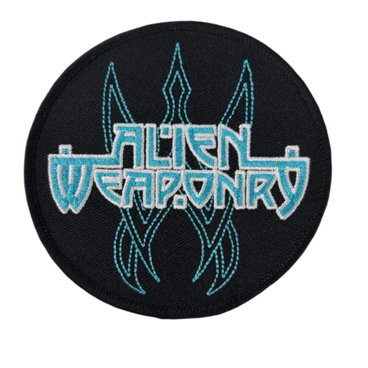 Round black patch with 'Alien Weaponry' text and blue designs. 