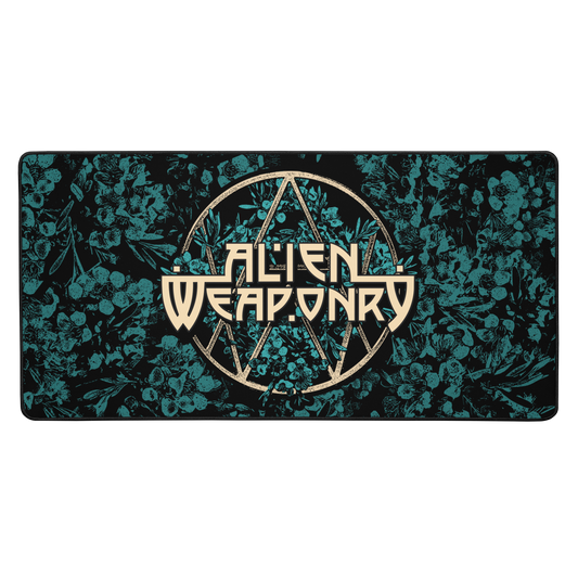 A rectangular gaming mouse pad with a black background, teal floral pattern, and a central gold-colored 'Alien Weaponry' logo, shown against a plain white background.